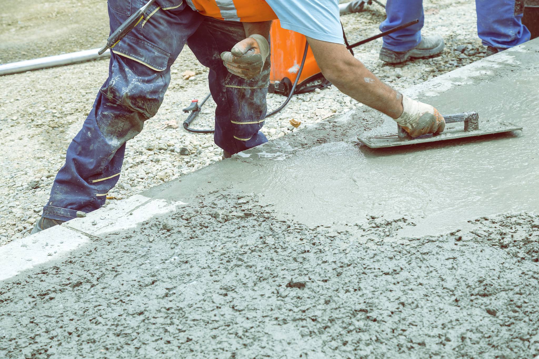 Craftsman leveling concrete with trowel