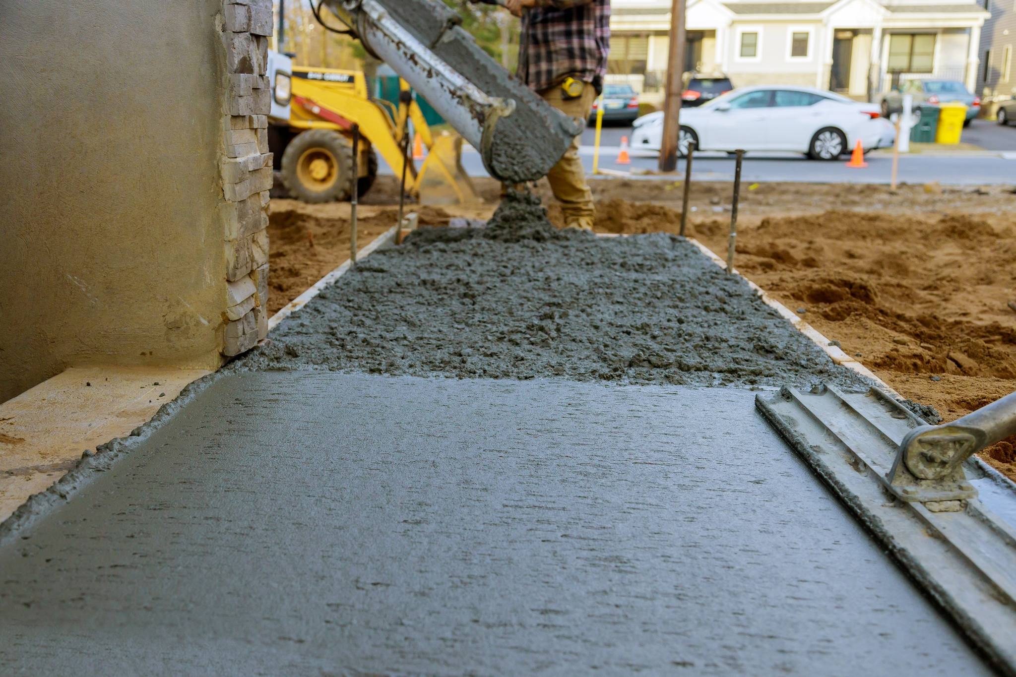 Construction worker pouring reinforced concrete