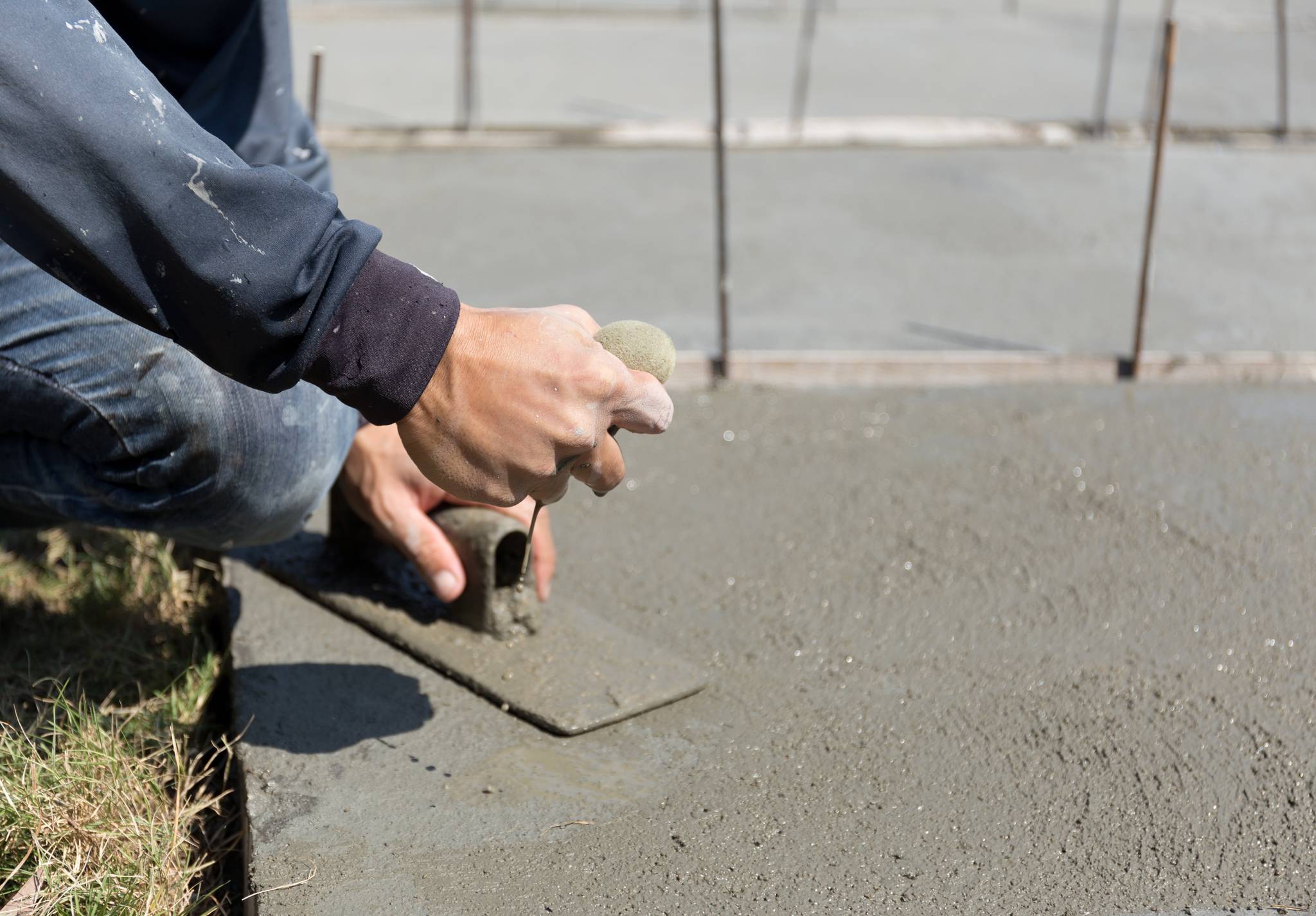 Worker smoothing concrete floor