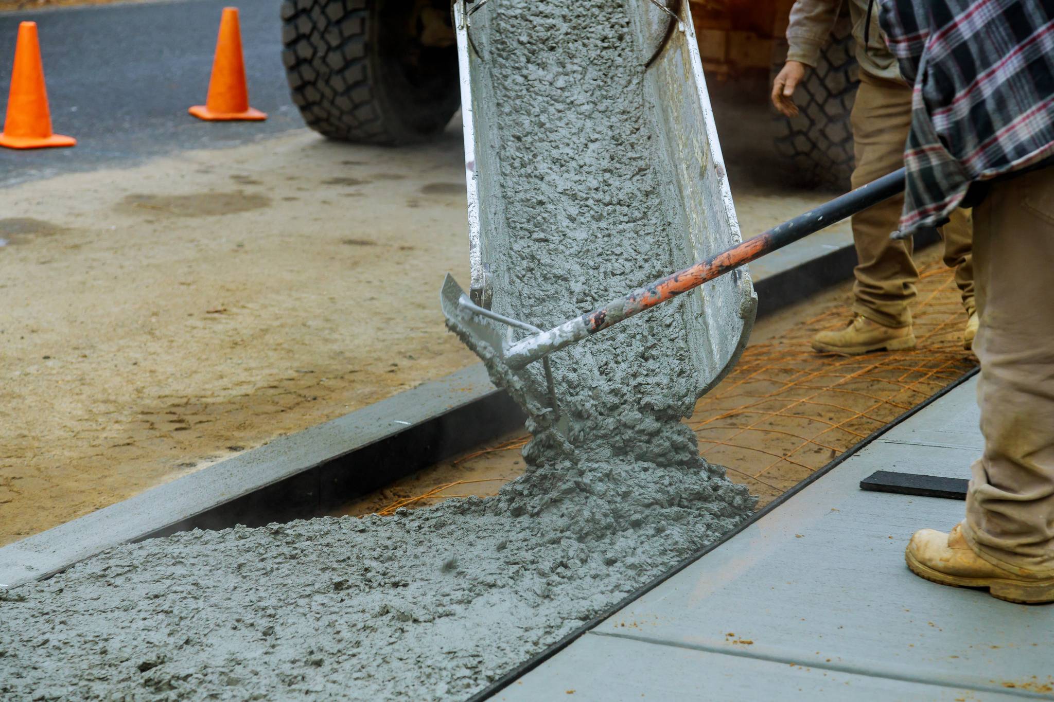 Worker laying concrete pavement